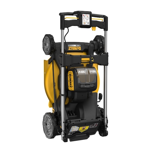 DEWALT cordless lawn mower, upright for storage, yellow and black design, wheels visible.