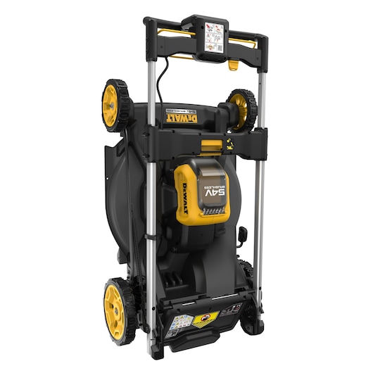 DEWALT lawn mower stored upright, yellow and black, four wheels, compact foldable design.