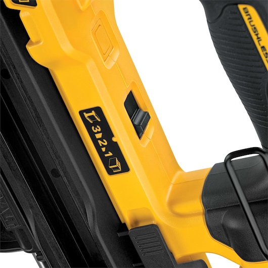 Close-up of a yellow DEWALT tool with a numbered adjustment switch on its body.