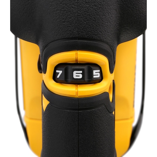 Close-up of a DEWALT tool's black and yellow speed control dial labeled 5, 6, and 7.