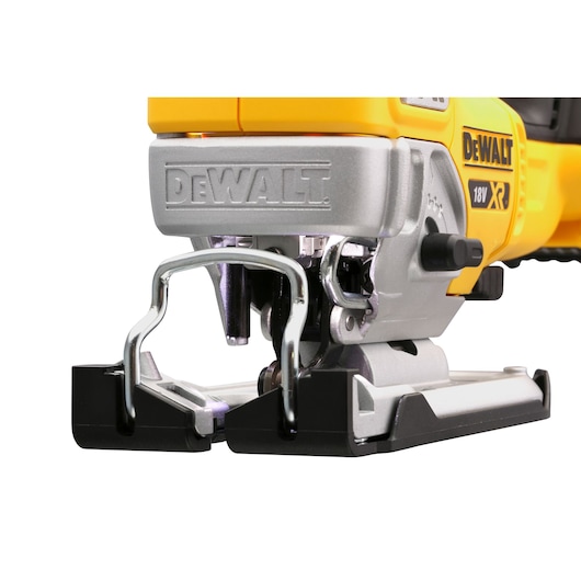 Close-up of a DEWALT 18V XR cordless jigsaw power tool with metal base and safety guard.
