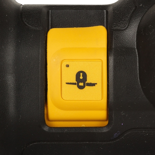 Close-up of a yellow Dewalt reciprocating saw blade lock button on a black power tool handle.