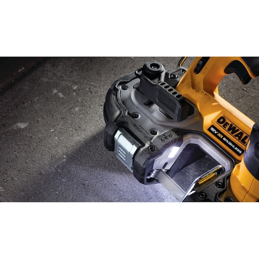 Close-up of a DEWALT 18V XR brushless power tool on a concrete surface, featuring built-in LED work light.