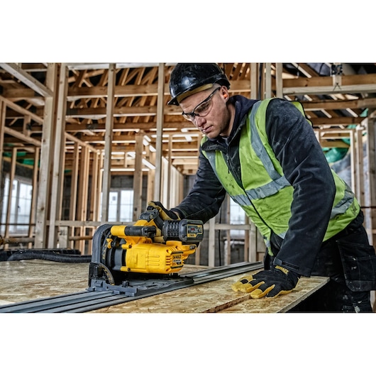 DEWALT DCS520T2-XE, DCS520T2 in use in construction. Worker operates yellow photography tool on wooden board.