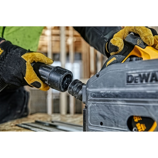 DEWALT DCS520T2-XE, DCS520T2 saw tool in use, gloved hand connecting accessory. Photography category.