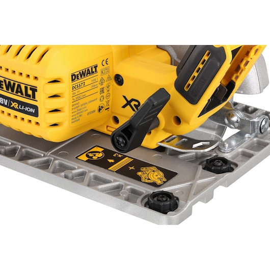 Close-up of the DEWALT DCS572NT cordless circular saw base and adjustment lever.