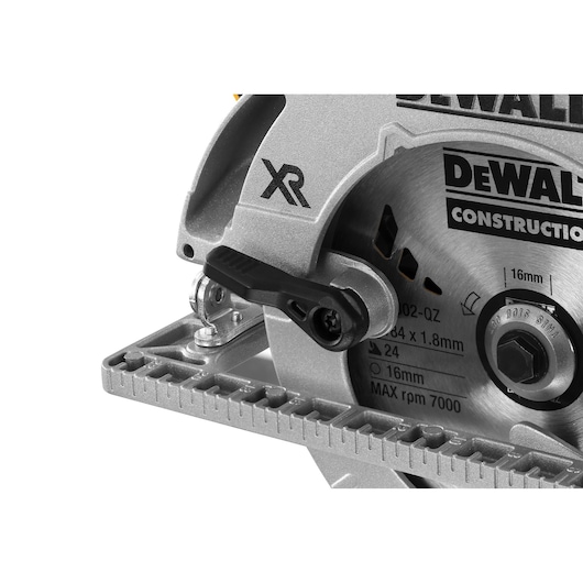 Close-up of DEWALT circular saw, showing blade, guard, and adjustment knob with XR marking.