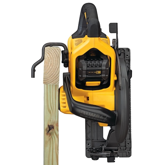 DEWALT circular saw cutting wooden beam, viewed from above on white background.