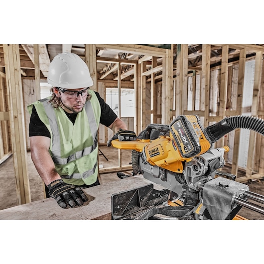 DEWALT DCS781X2-QW, DCS781X2 saw used on site by worker in safety gear. Product from Photography category.