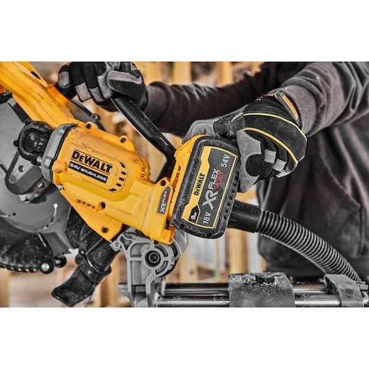 DEWALT XR FLEXVOLT saw in use, SKUs DCS781X2-QW, DCS781X2, yellow tool held by gloved hands.