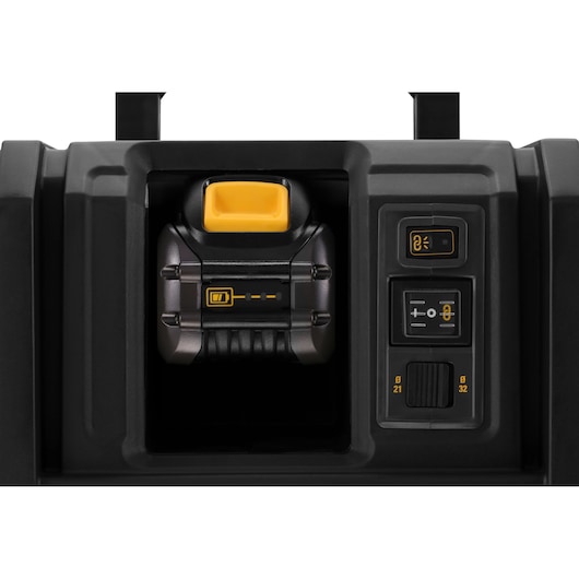 Close-up of DEWALT DCV586MT2 battery compartment and control panel with yellow button and indicators.