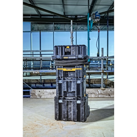 DEWALT DCV586MT2 dust extractor and tool storage stack at a construction site.
