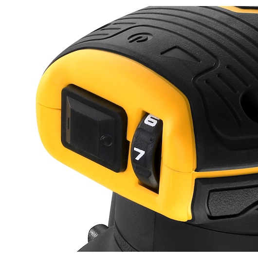 Close-up of DEWALT power tool showing its black speed control dial and yellow casing.