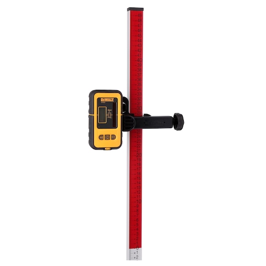DEWALT laser detector attached to a red measuring rod, used for precise leveling in construction and photography.