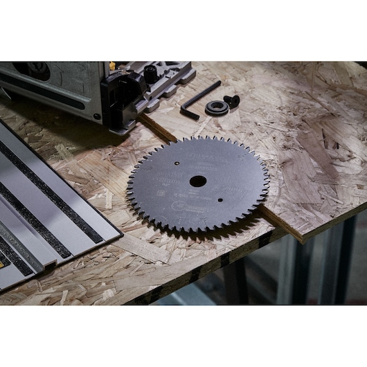 DEWALT DT1088 circular saw blade and accessories on a wooden workbench.