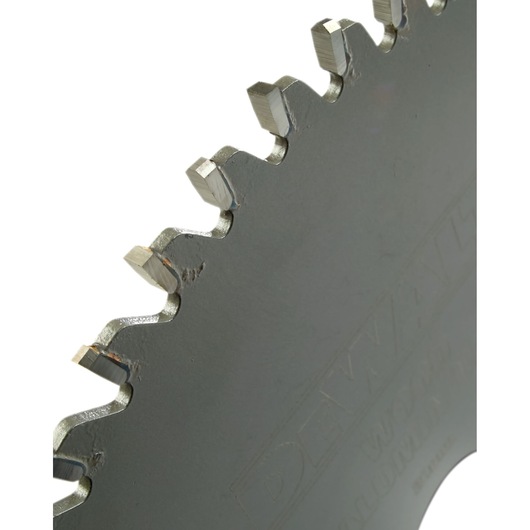 Close-up of a DEWALT saw blade showing the sharp metal teeth and part of the circular edge.