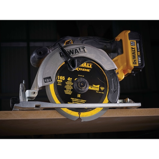 DEWALT DT1471 18V circular saw cutting wood, close-up of blade and tool.