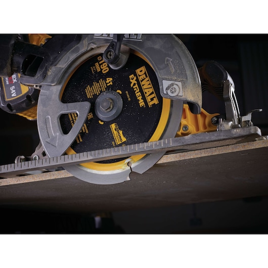 DEWALT circular saw DT1472 cutting material with extreme blade, close-up view of tool in action.