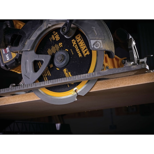 DEWALT circular saw cutting wood with DT1472 blade. Close-up view shows blade detail during operation.