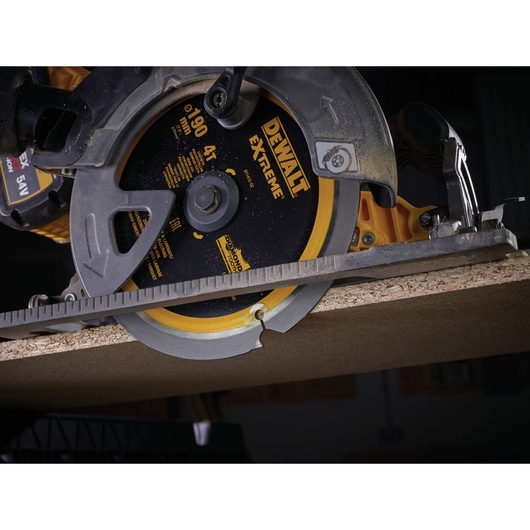 DEWALT circular saw blade DT1472 cutting wood plank in close-up view.