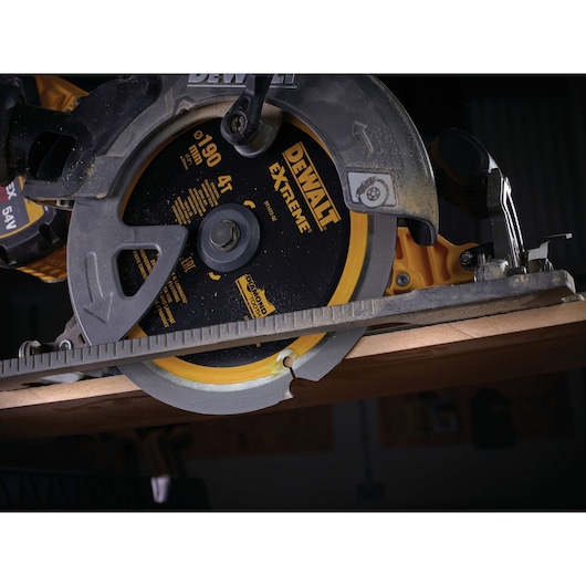 Close-up of DEWALT DT1472 circular saw cutting wood, showing blade and safety guard.