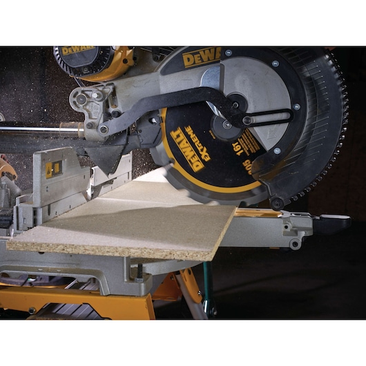 DEWALT circular saw cutting a piece of wood on a workbench, with sawdust visible.