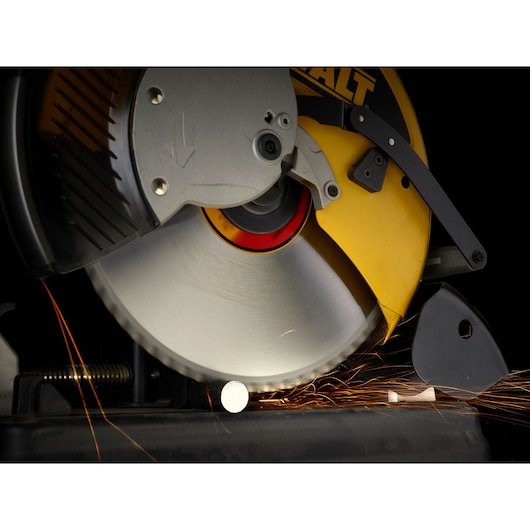 Close-up of DEWALT circular saw cutting metal, producing sparks.