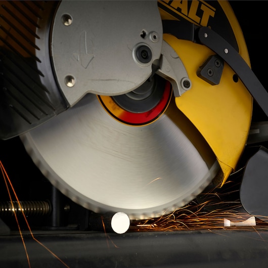 DEWALT circular saw cutting metal, sparks flying as the blade slices through a metal rod.