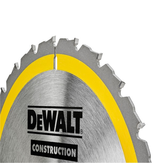 Close-up of a DEWALT circular saw blade with yellow rim and sharp teeth for construction use.