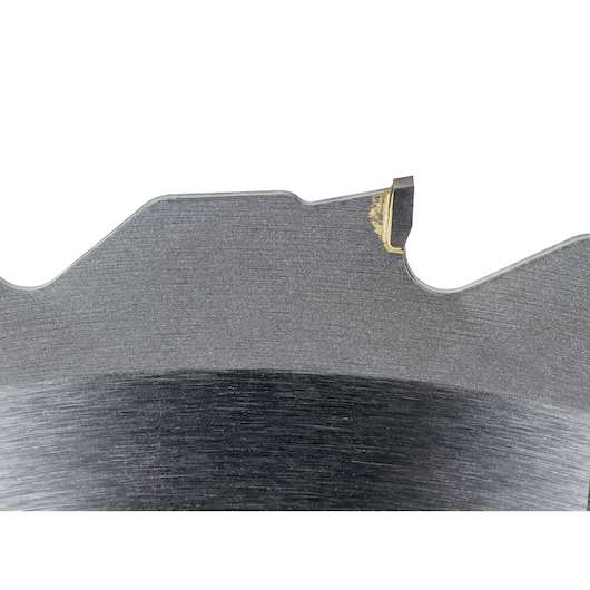 Close-up view of a DEWALT DT1953 circular saw blade tooth, showing the metal finish and a bit of residue on the tip.