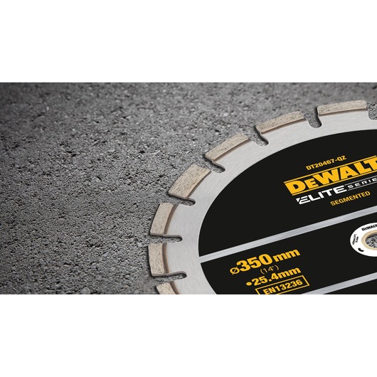 Close-up of DEWALT segmented saw blade for cutting, showing measurement and Elite Series branding on concrete.