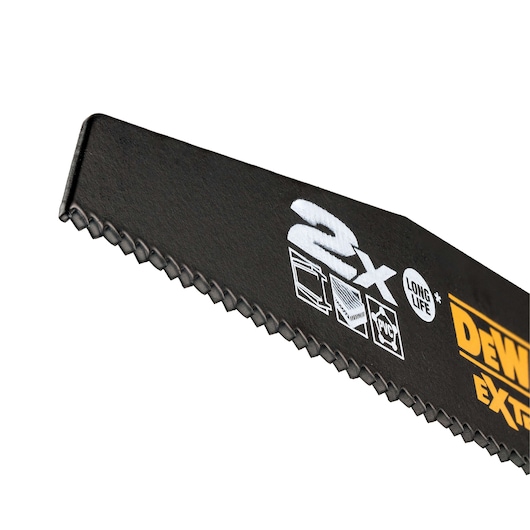 Close-up of a DEWALT saw blade with toothed edge and printed symbols for long life and material compatibility.