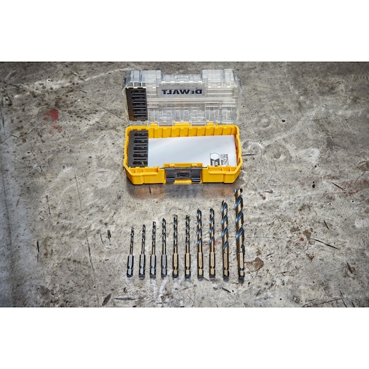DEWALT DT70702 drill bit set in yellow case, displayed open on a metal surface with bits arranged in front.