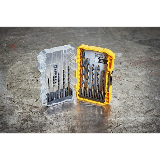 DEWALT hex shank drill bit set in a yellow and clear plastic case, shown open on a workshop table.