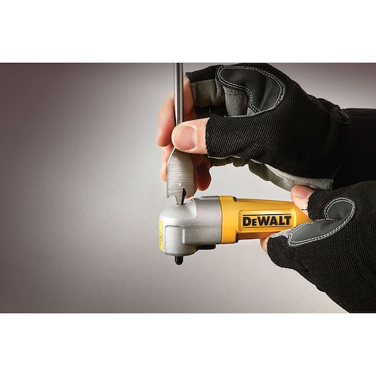 Gloved hands use a DEWALT right angle attachment with a drill bit, close-up on tool and hands.