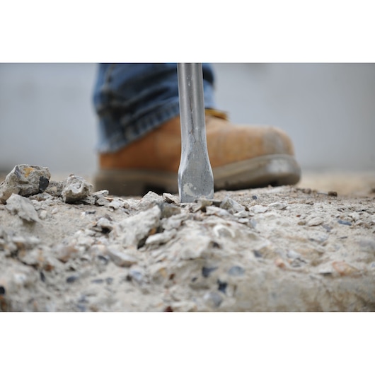DEWALT DT8088-QZ, DT8088 chisel breaking concrete. Photography product. Worker boot visible.