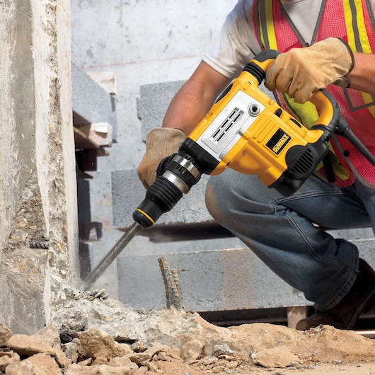 DEWALT hammer drill used on concrete. SKUs: DT8088-QZ, DT8088. Construction scene. Photography category.