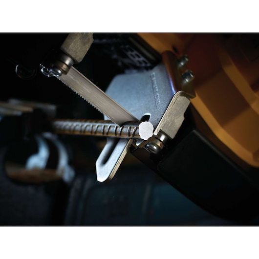 Close-up of a DEWALT saw blade cutting through a metal rebar with precision.