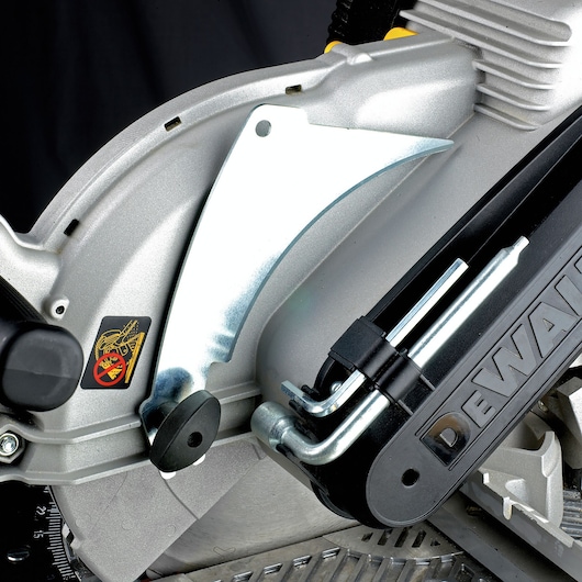 Close-up of DEWALT DW743N saw body showing metal blade guard and safety sticker.