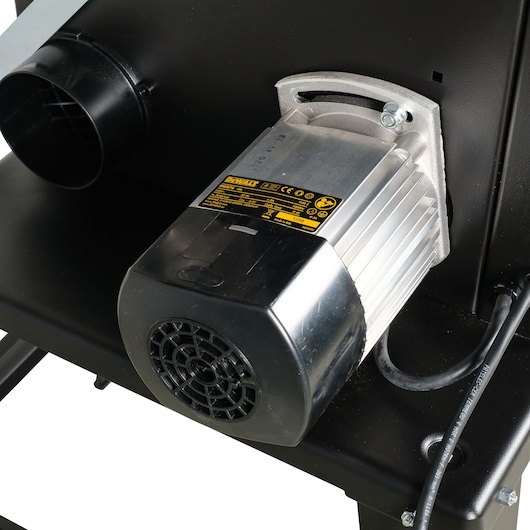 Close-up of a DEWALT DW876 electric motor mounted on a metal base with visible label and wires.