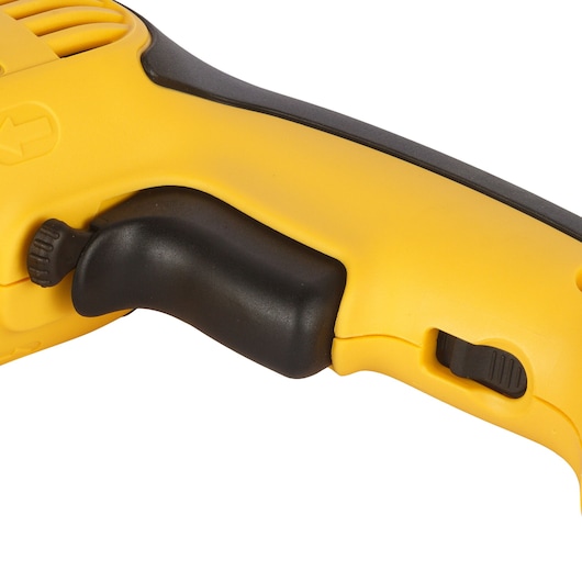 Close-up of a yellow and black DEWALT drill handle with trigger and speed control switch visible.