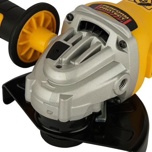 Close-up of a DEWALT DWE4347 yellow and black angle grinder handle and metal housing.
