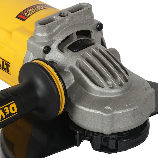 Close-up of a DEWALT angle grinder showing handle and metal casing.