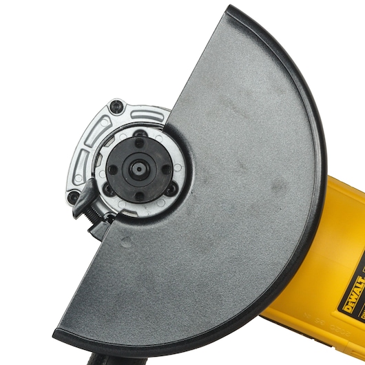 Close-up view of a DEWALT angle grinder with a protective guard and yellow handle visible.