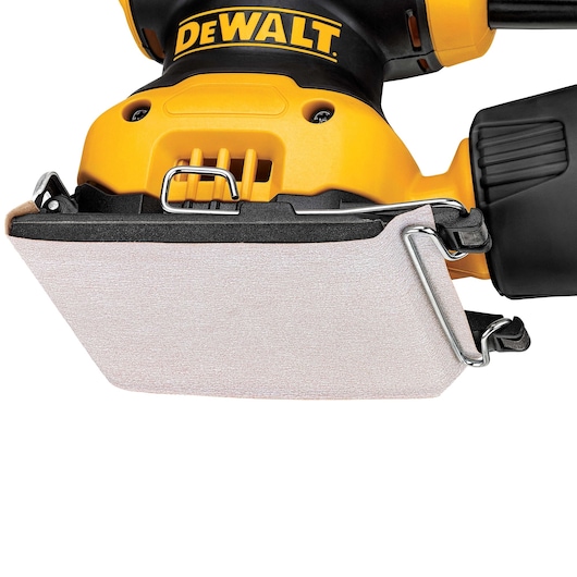 Close-up view of a DEWALT handheld electric sander with a rectangular sanding pad, featuring a yellow and black design.