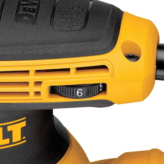 Close-up view of a DEWALT power tool showing the adjustable speed dial on a yellow and black casing.