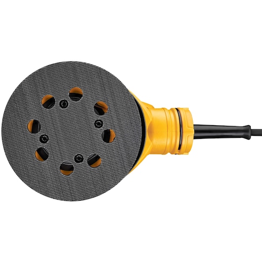 Close-up view of a DEWALT DWE6423 random orbit sander showing the round sanding pad with multiple ventilation holes and a yellow body.