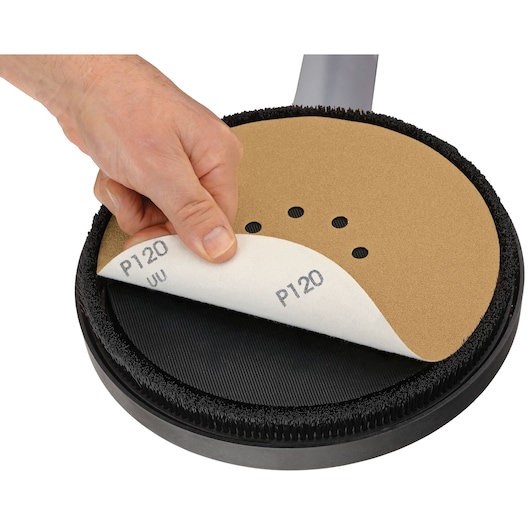 Hand changes sanding disc on DEWALT DWE7800, DWE7800-QS tool. Disc labeled P120, used in photography category.