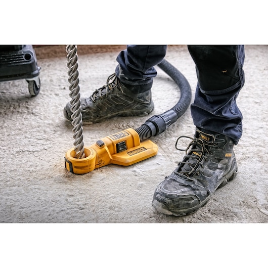 DEWALT tool for drilling, SKUs DWH050, DWH050K, DWH050-XJ, used on concrete floor by worker in boots.