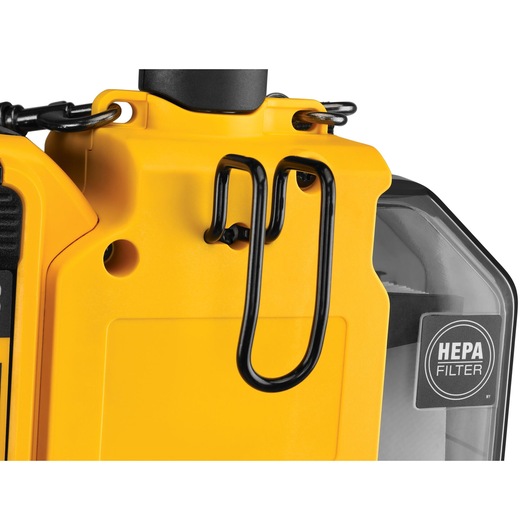 Close-up of a yellow DEWALT device with a HEPA filter and black metal clip detail.